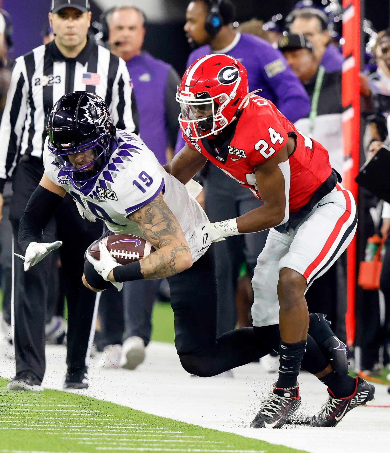 TCU Horned Frogs tight end Jared Wiley (19) is pulled out of bounds by Georgia Bulldogs...