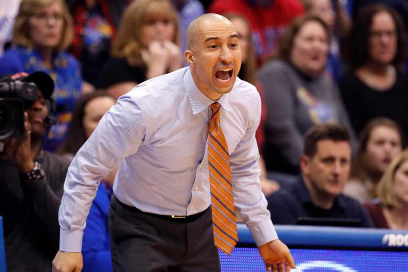 Texas head coach Shaka Smart talks to his players during the second half of an NCAA college...