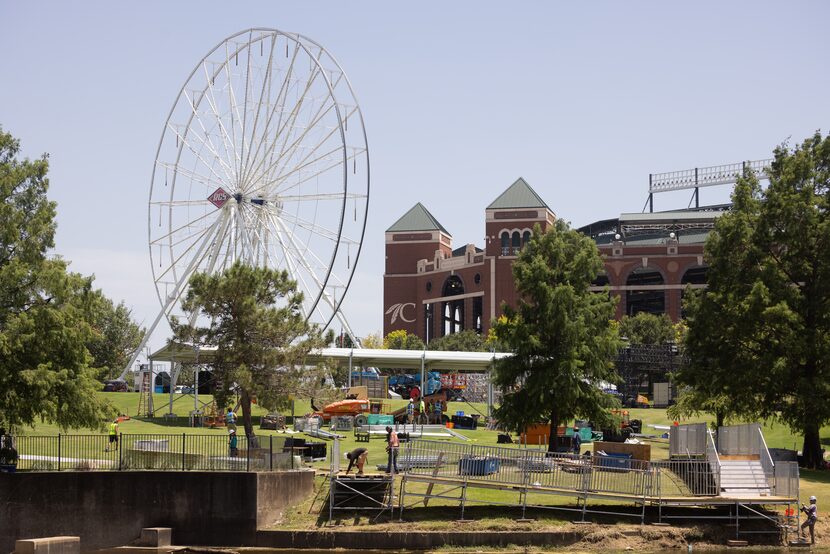 A Ferris wheel stands amid construction of the MLB All-Star Village outside Choctaw Stadium...