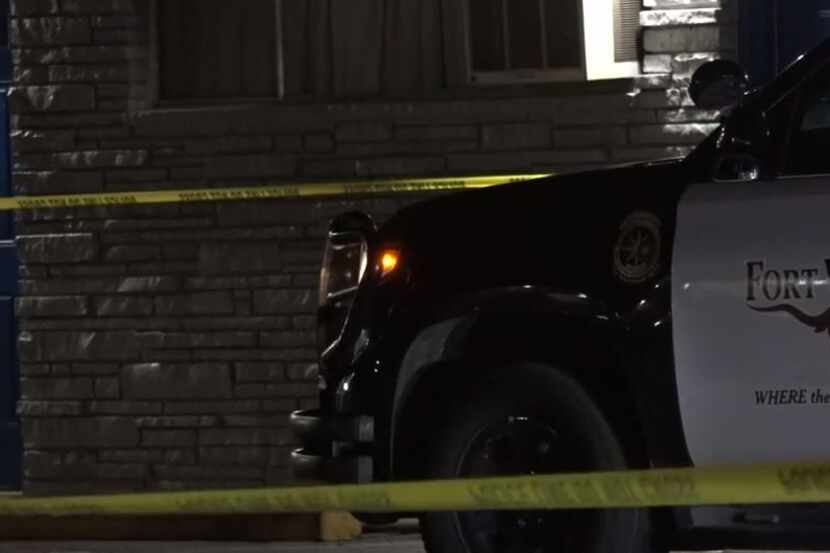 A Fort Worth police vehicle sits outside a motel where a body was discovered in a bathtub...