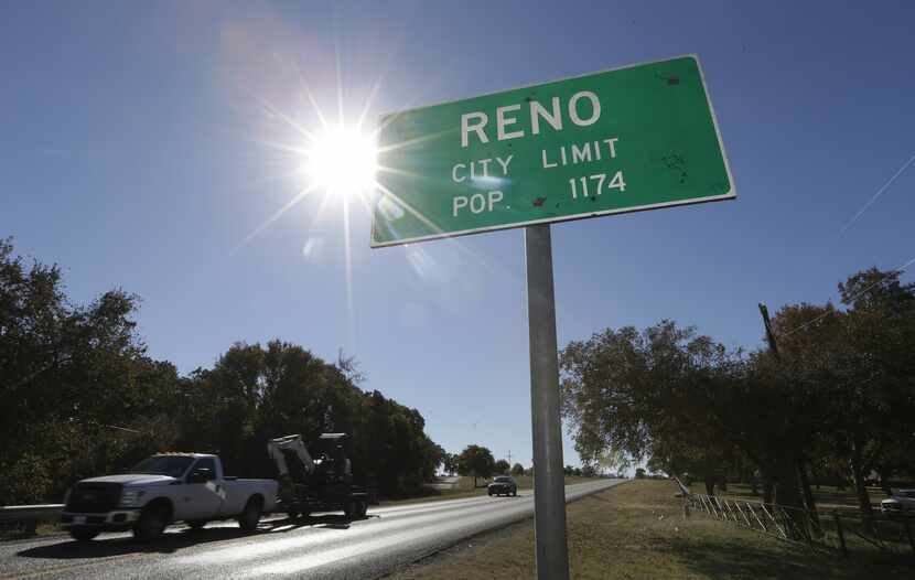 In this Wednesday, Nov. 19, 2014 photo, vehicles drive past the city limits of Reno, Texas....