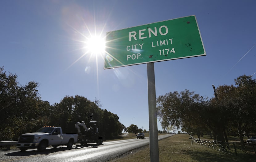 In this Wednesday, Nov. 19, 2014 photo, vehicles drive past the city limits of Reno, Texas....