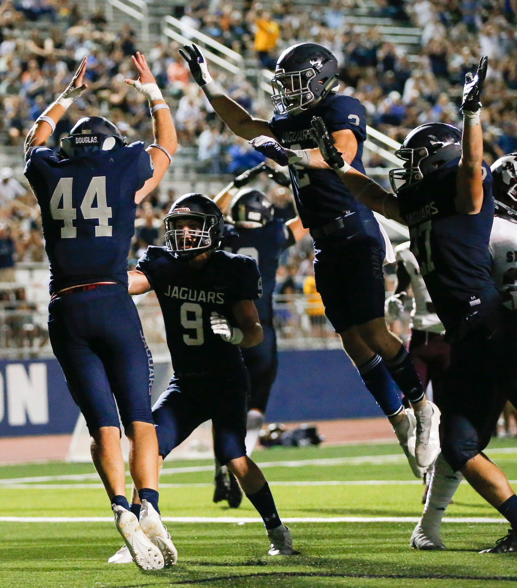 Flower Mound senior linebacker Ryan Brubaker (44) is congratulated by teammates after...