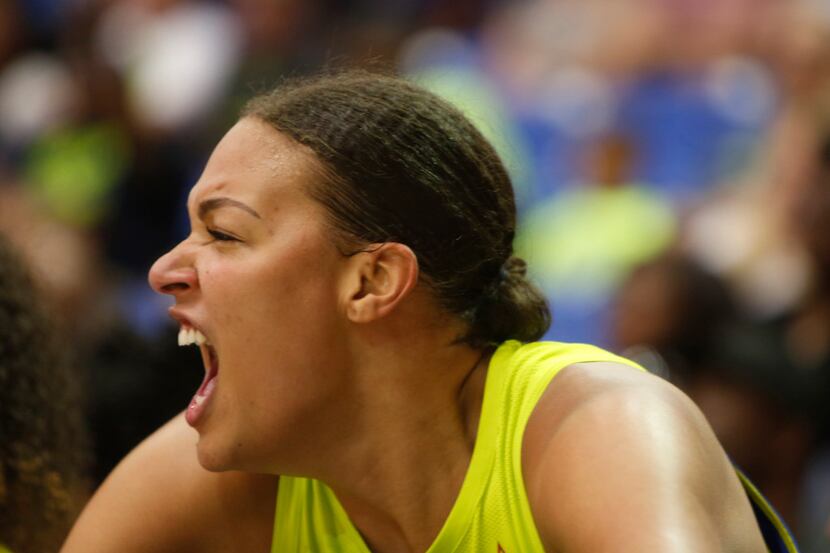 Dallas Wings center Liz Cambage (8) voices her support fro teammates from the bench during...