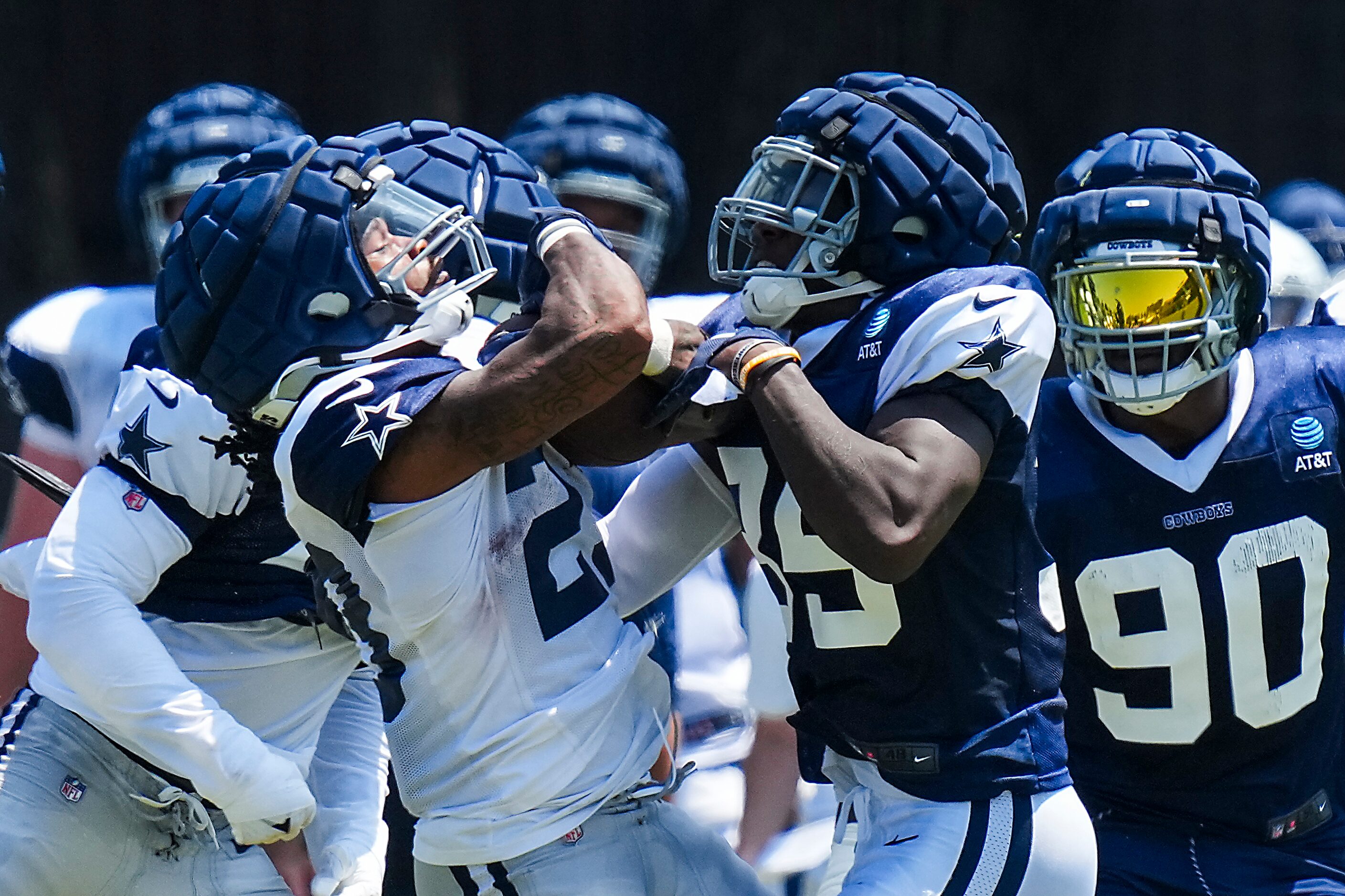 Dallas Cowboys running back Rico Dowdle (23) is hit by linebacker DeMarvion Overshown (35)...