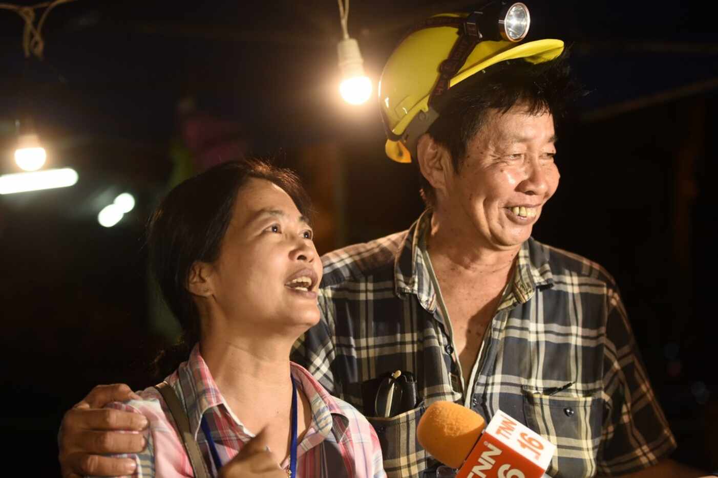 Family members celebrate while camping out near Than Luang cave following news all members...