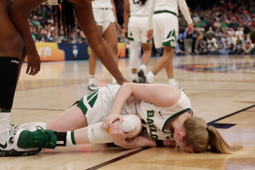 Baylor forward Lauren Cox (15) holds her left knee, during the second half of the Final Four...