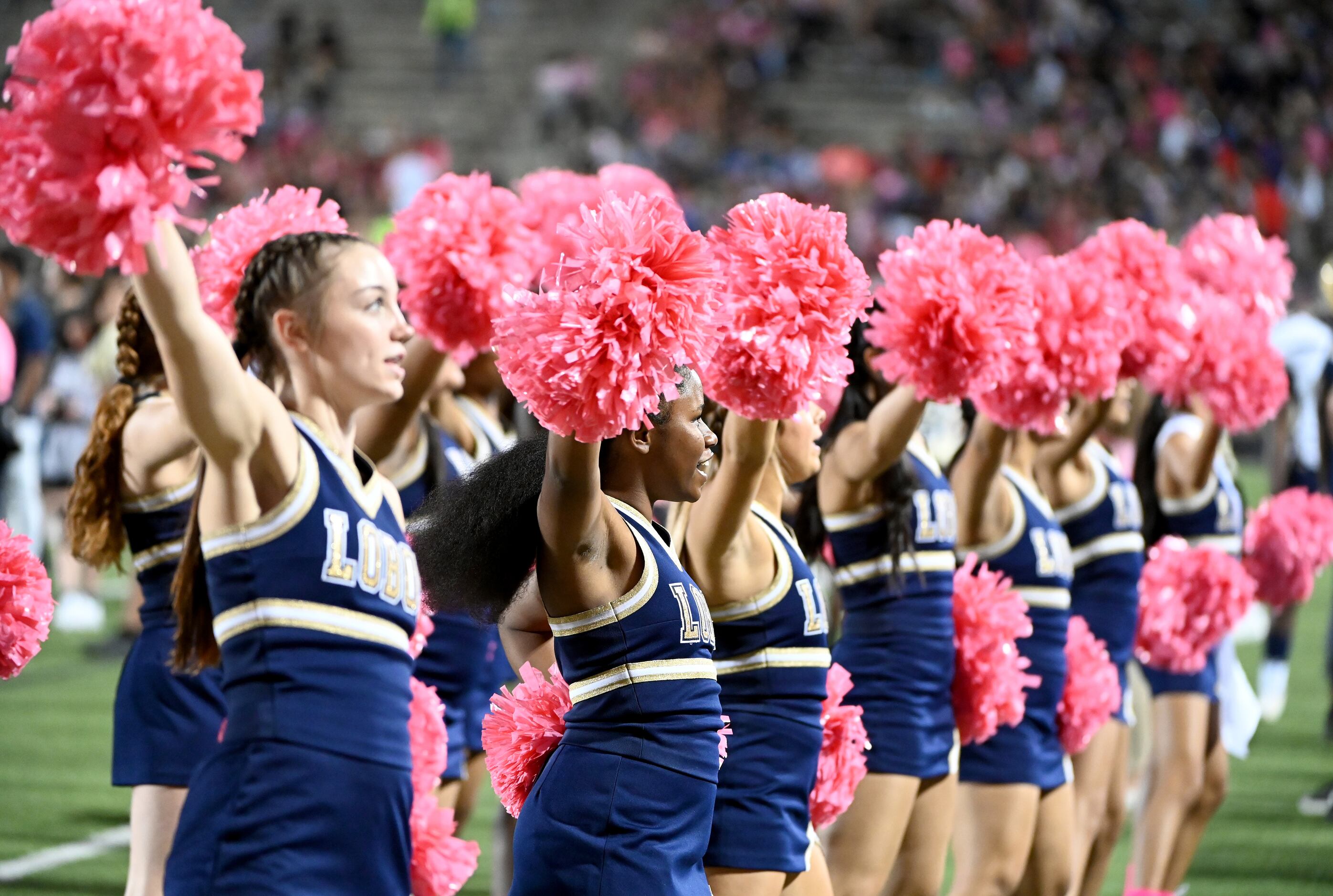 Little Elm cheerleaders perform in the first half of a high school football game between...