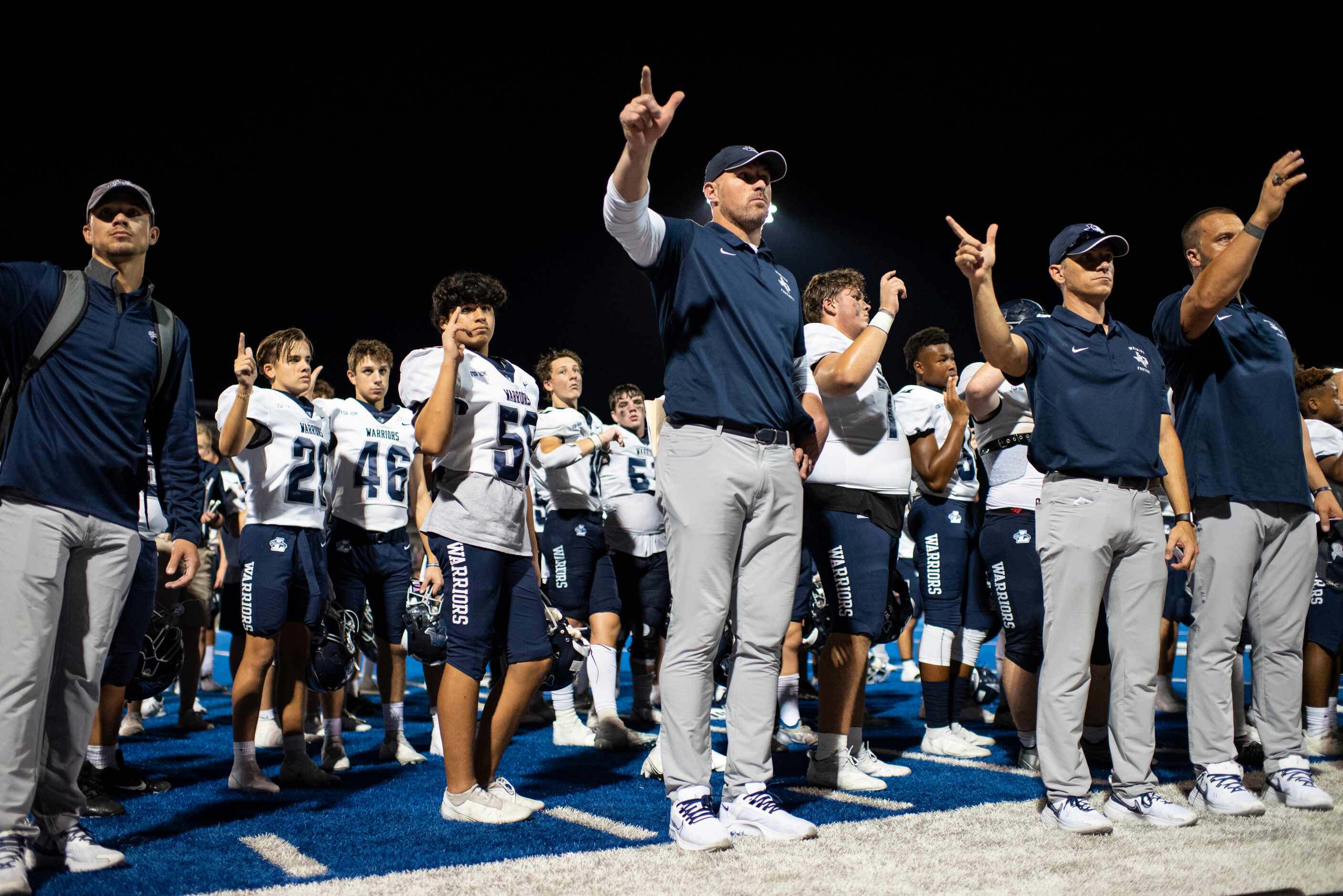 Argyle Liberty Christian Head Coach Jason Witten waves his hand along with the school fight...