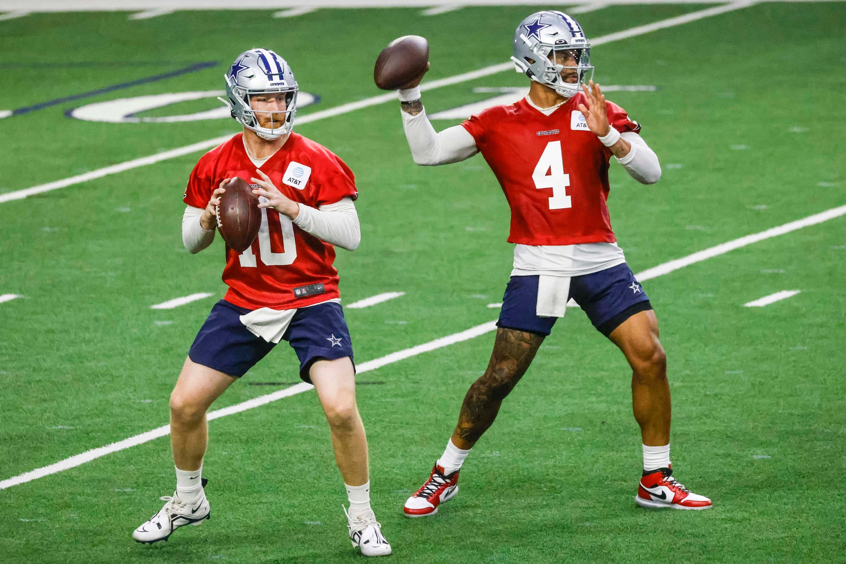Dallas Cowboys quarterbacks Dak Prescott (right) and Cooper Rush throw the ball during OTA...
