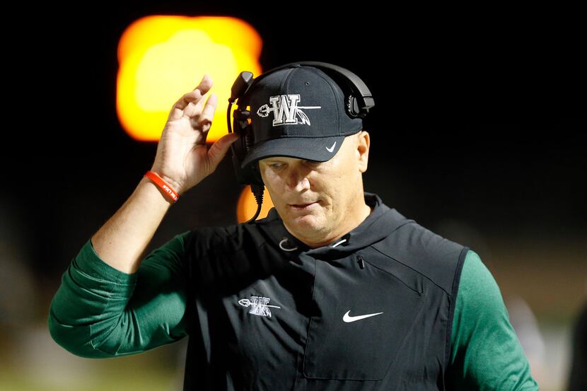Waxahachie head coach Jon Kitna paces the sideline in the first half against Mansfield...