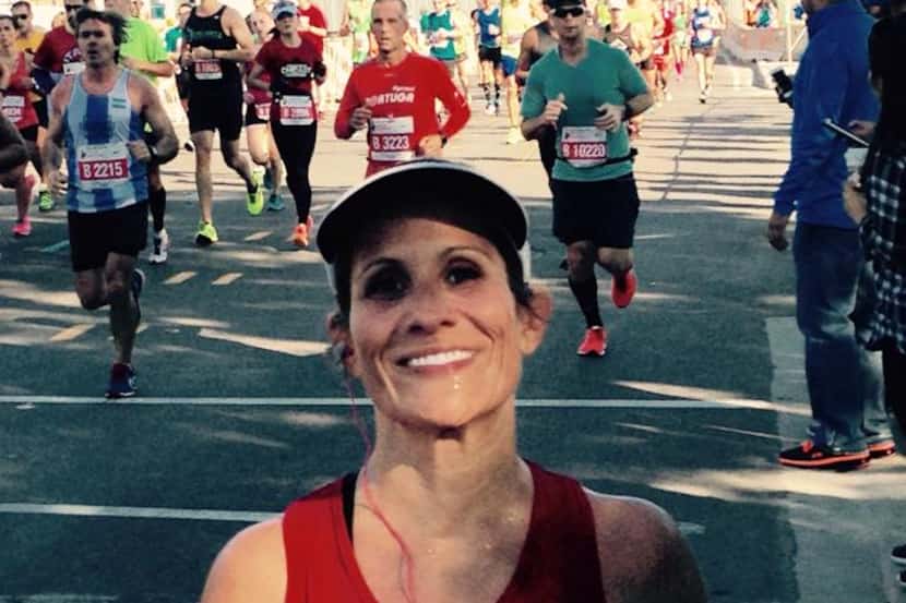 Susan Orendain smiles as she reaches the 17-mile mark of this year's Chicago Marathon. With...