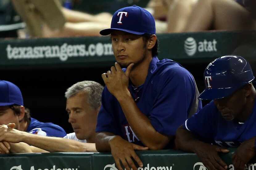 ARLINGTON, TX - JUNE 9: Yu Darvish #11 of the Texas Rangers looks on from the dugout in the...