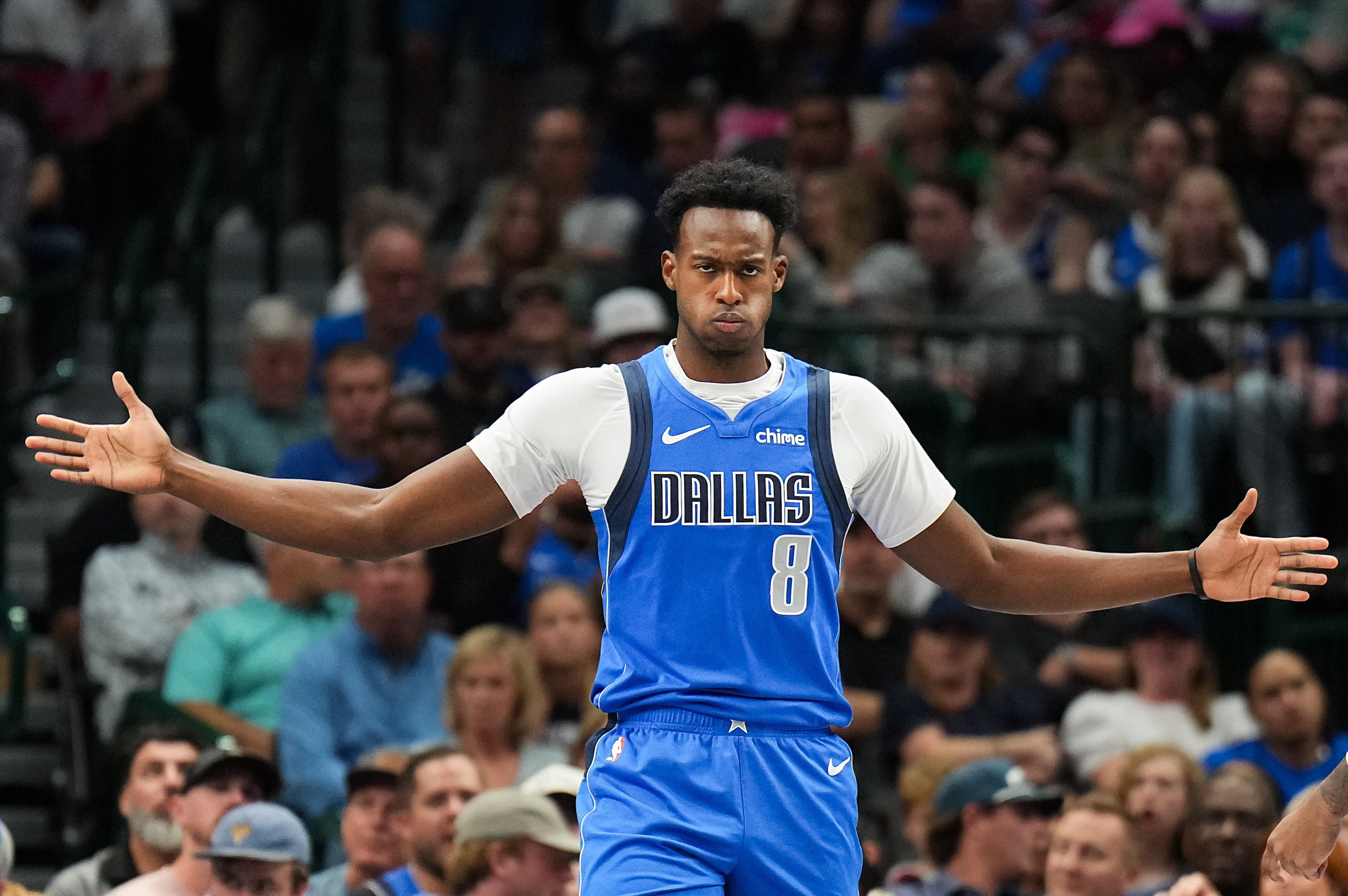 Dallas Mavericks forward Olivier-Maxence Prosper (8) reacts to a play during the first half...