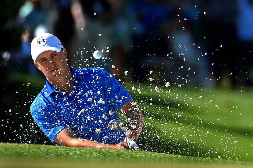 Jordan Spieth hits a shot from a sand trap along the 10th green during the final round of...