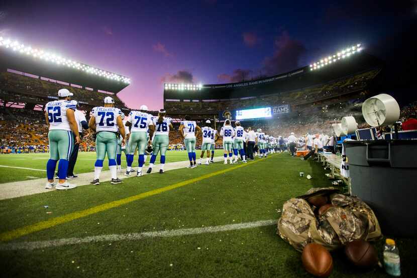 Dallas Cowboys line up on the sideline during the fourth quarter of an NFL preseason game...