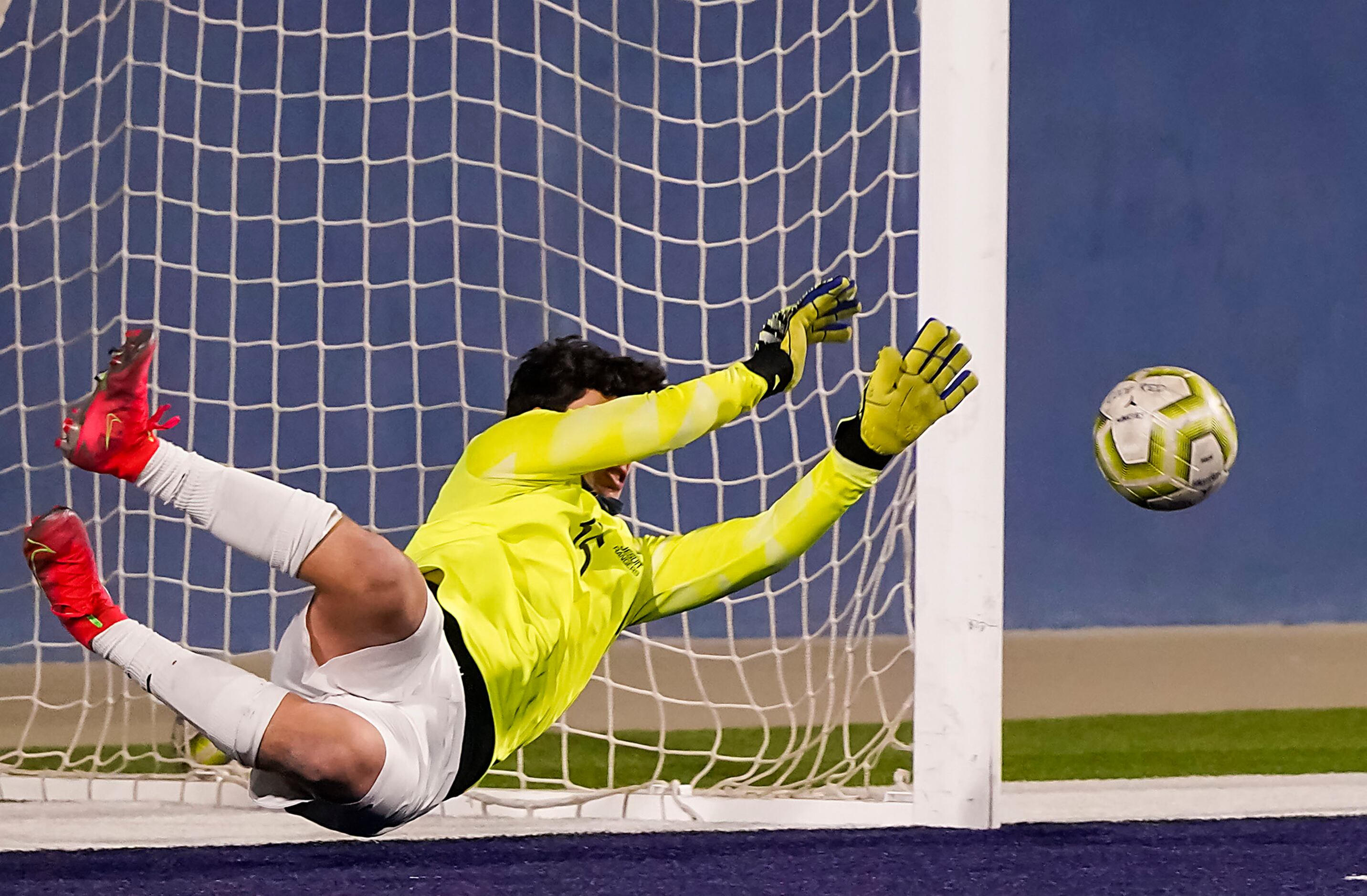 Jesuit goalkeeper Cole Hines makes a save on a shot by McKinney Boyd midfielder Baily Helms ...
