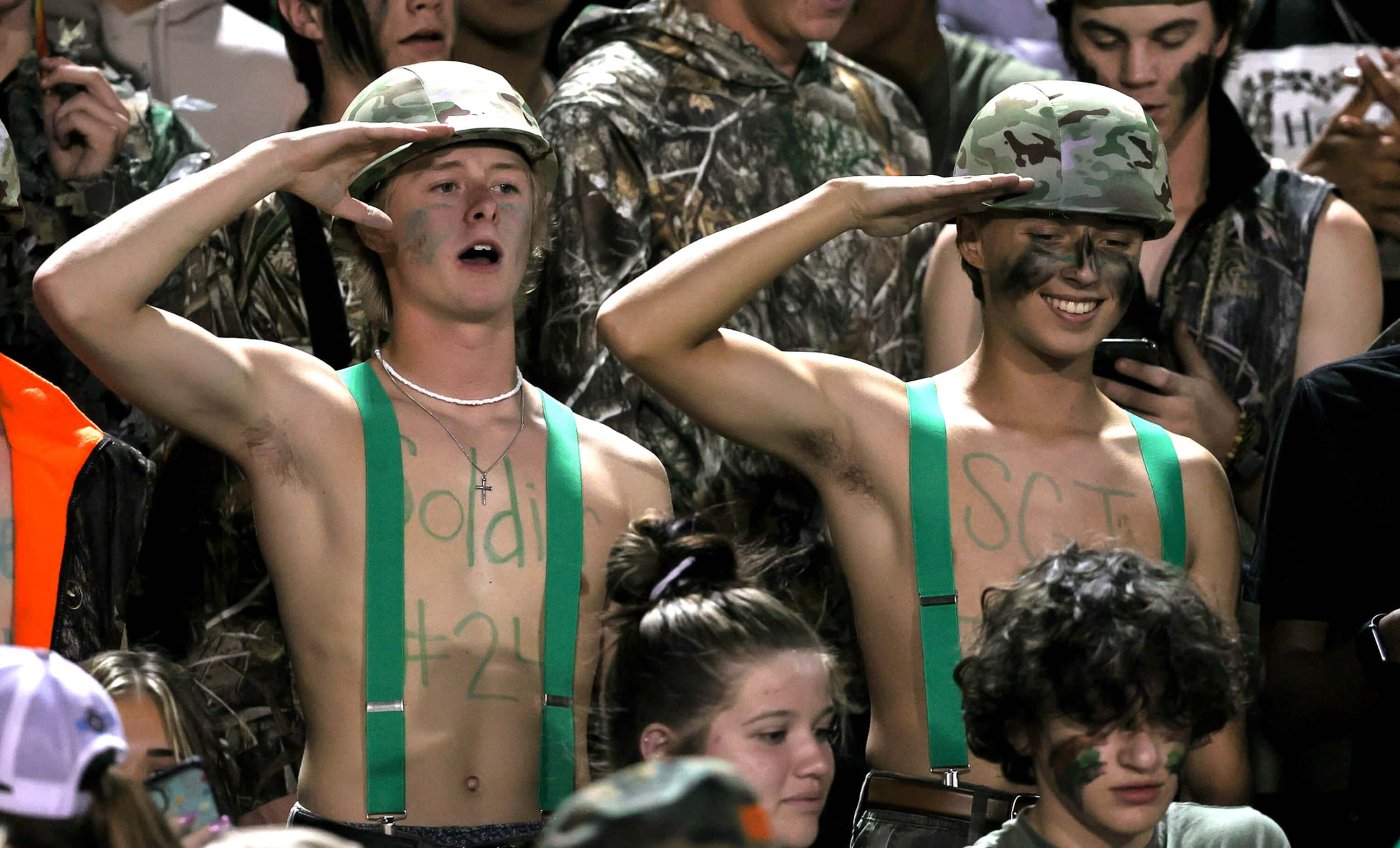 Some Lake Dallas students salute during the game against Argyle in a District 3-5A Division...