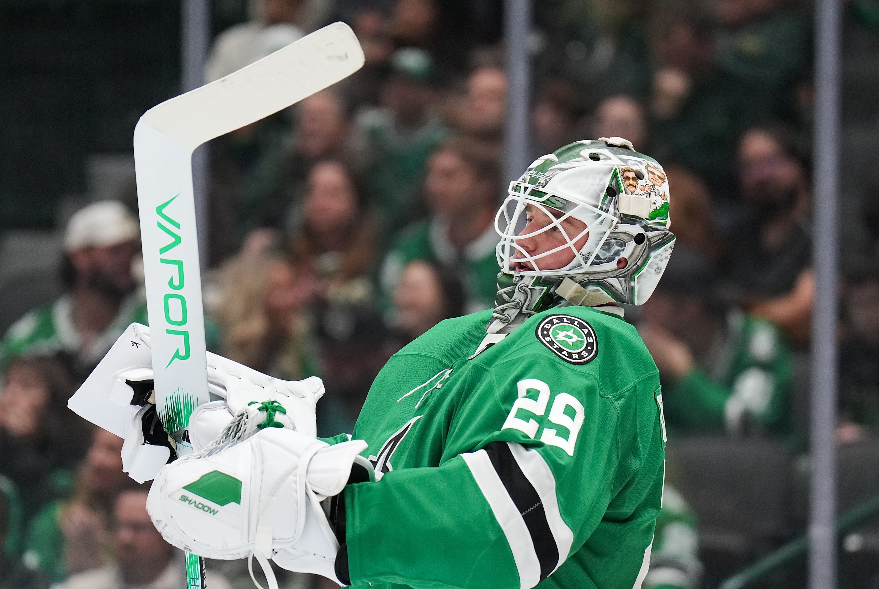 Dallas Stars goaltender Jake Oettinger pauses before a face off during the second period of...