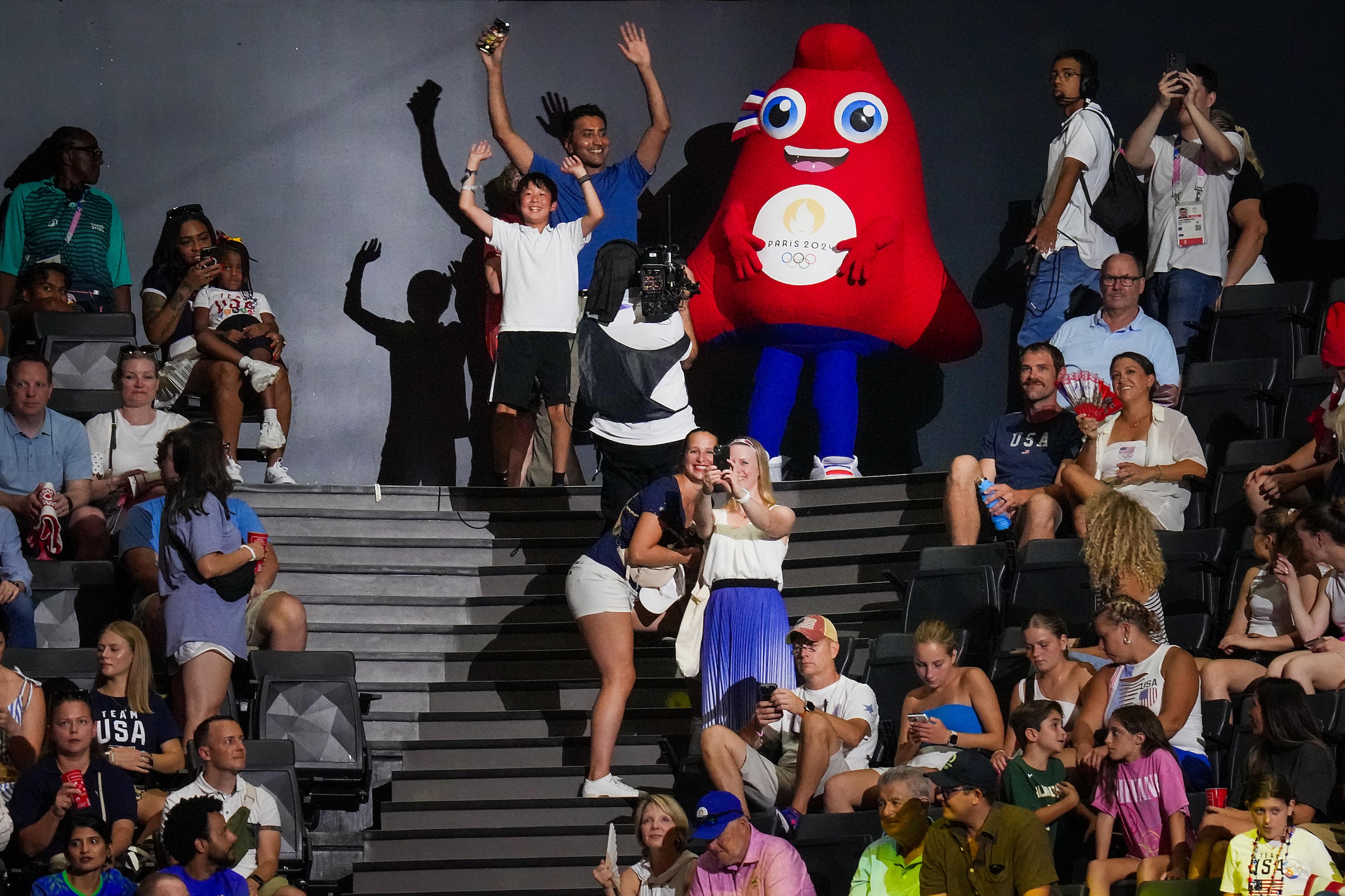 Fans pose for photos with the Paris 2024 Olympic mascot, Phryge, before the women’s...