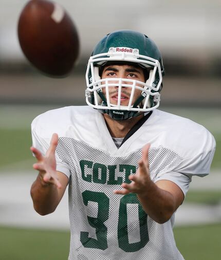 Arlington High School junior wide receiver Antonio Leonardi participates in drills during...