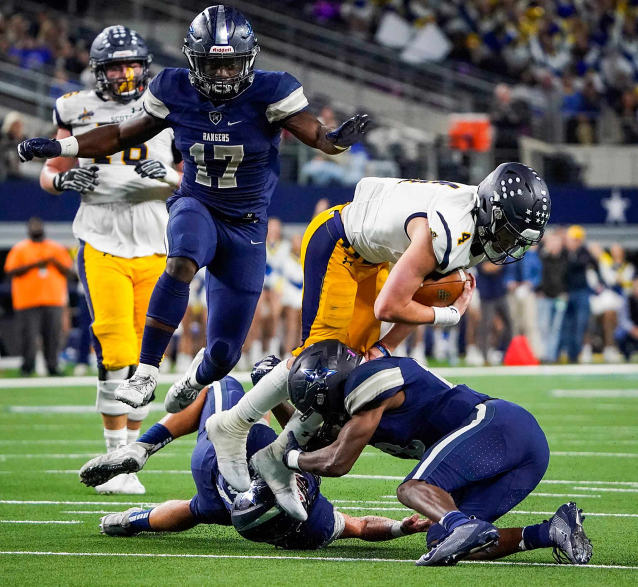 Highland Park quarterback Chandler Morris (4) is knocked off his feet by Frisco Lone Star...