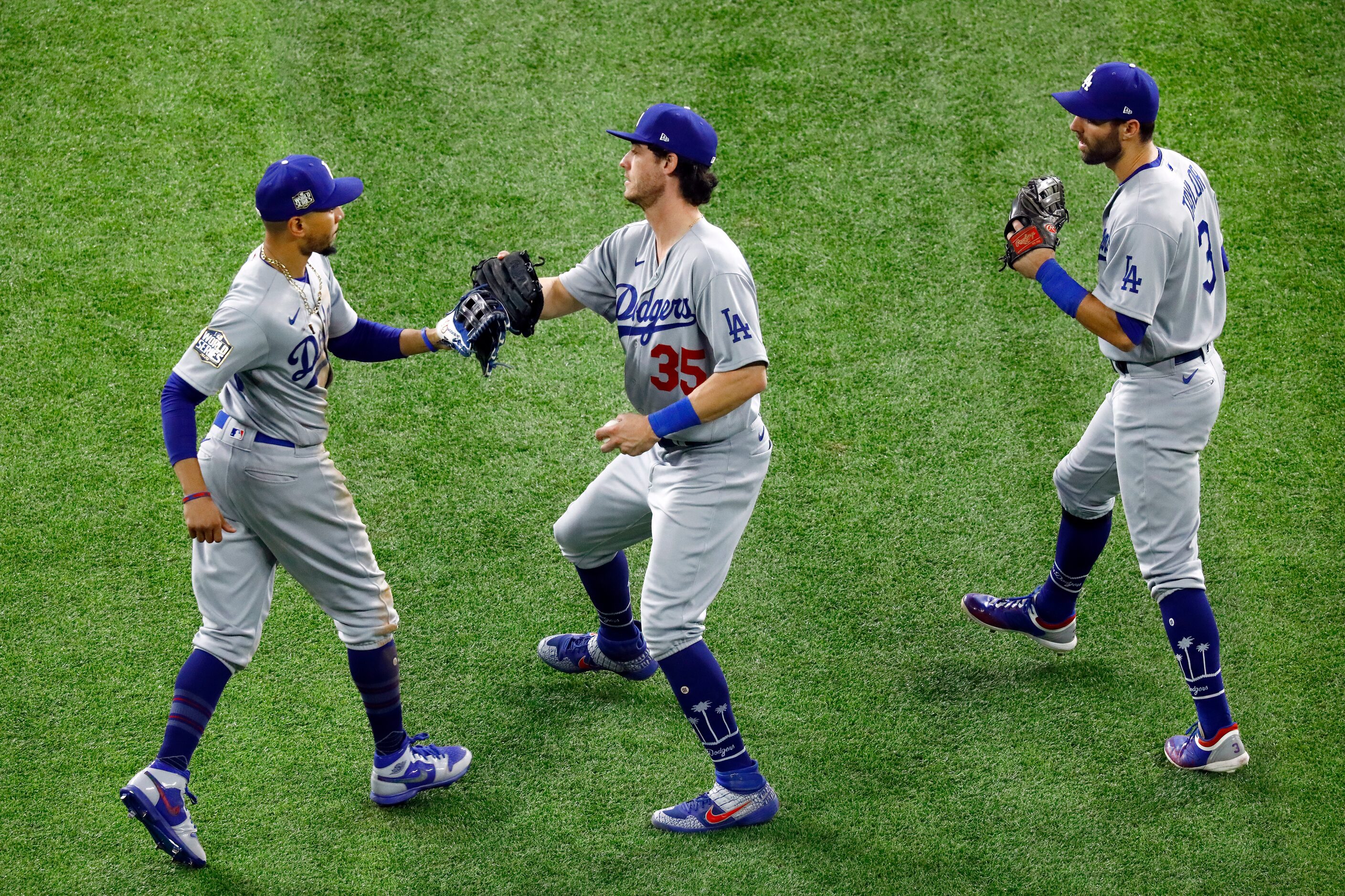 Los Angeles Dodgers outfielders, from left, Mookie Betts, Cody Bellinger (35) and Chris...