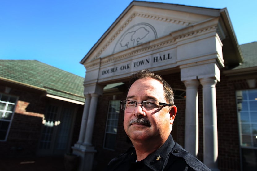  Double Oak Police Chief Derrick Watson is pictured outside of the Double Oak Town Hall on...