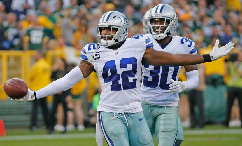 Dallas Cowboys strong safety Barry Church (42) celebrates his interception with teammate...