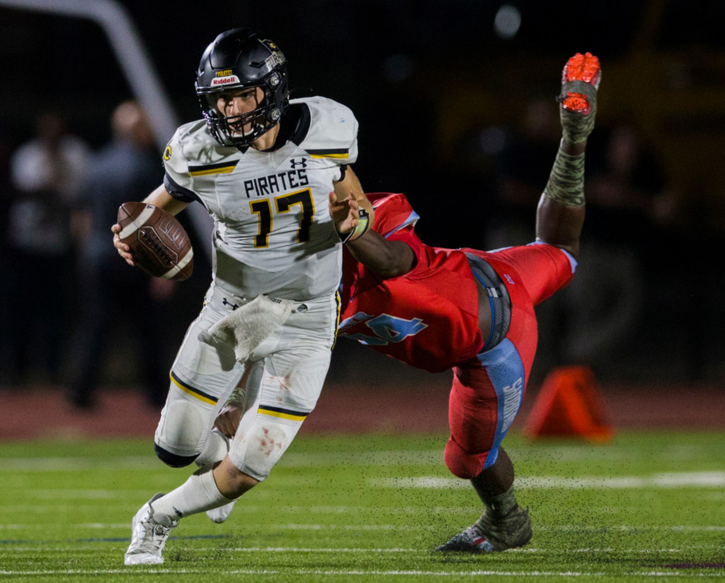 Crandall quarterback Holt Reese (17) is tackled by Carter linebacker Randy Anthony (54)...