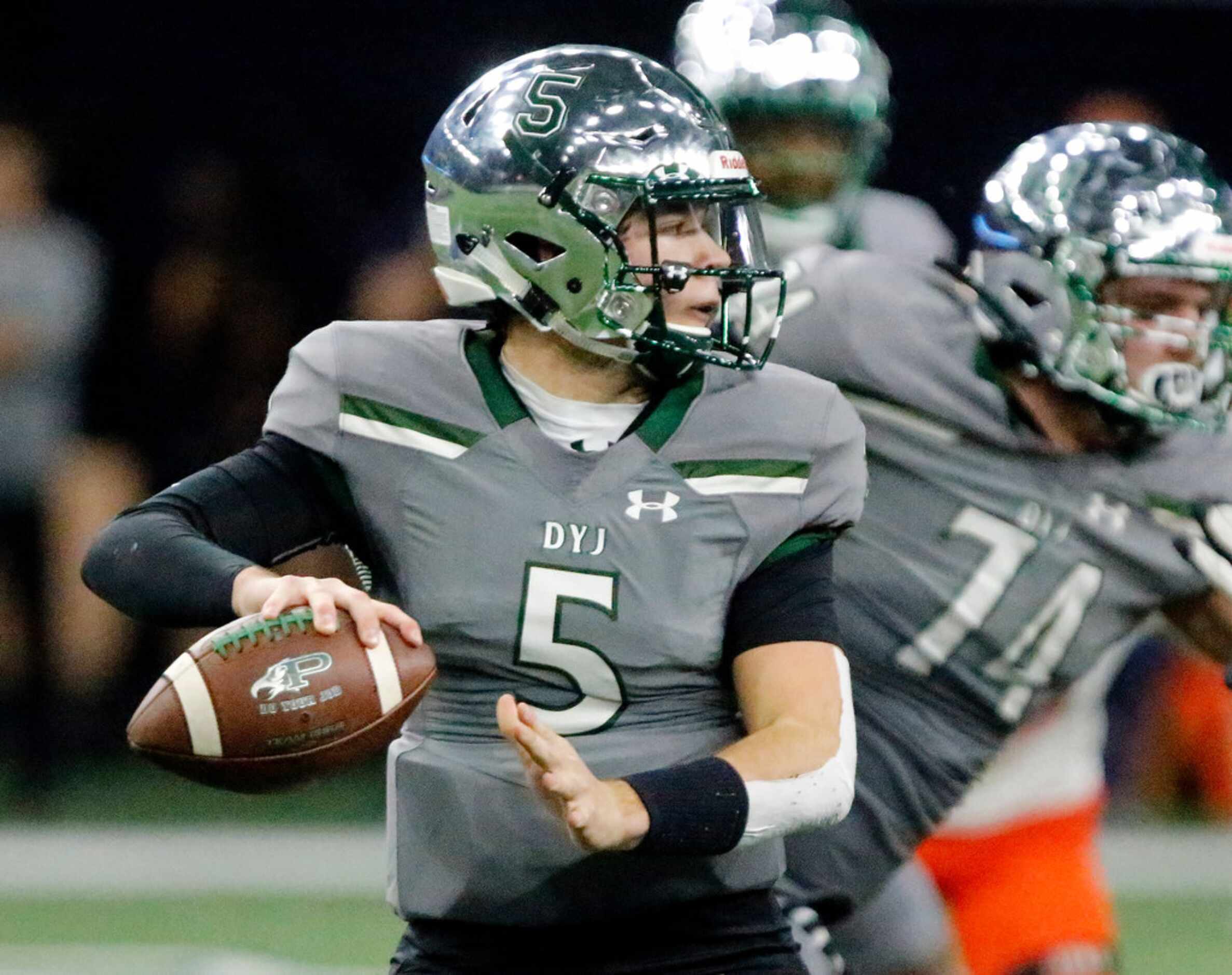 Prosper High School quarterback Jackson Bailey (5) throws a pass during the first half as...