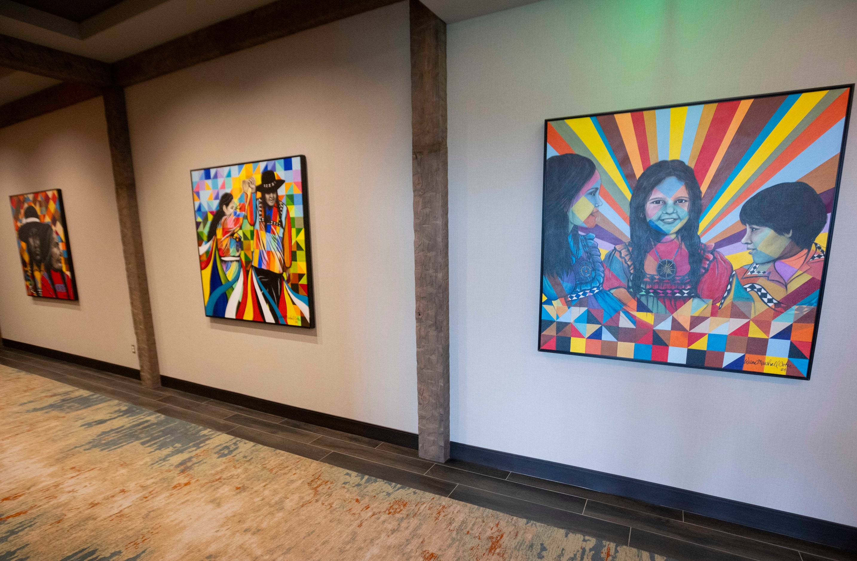 Paintings by Choctaw artist Wani Marshall from Wani Marshall Coker Art line an entry hall at...