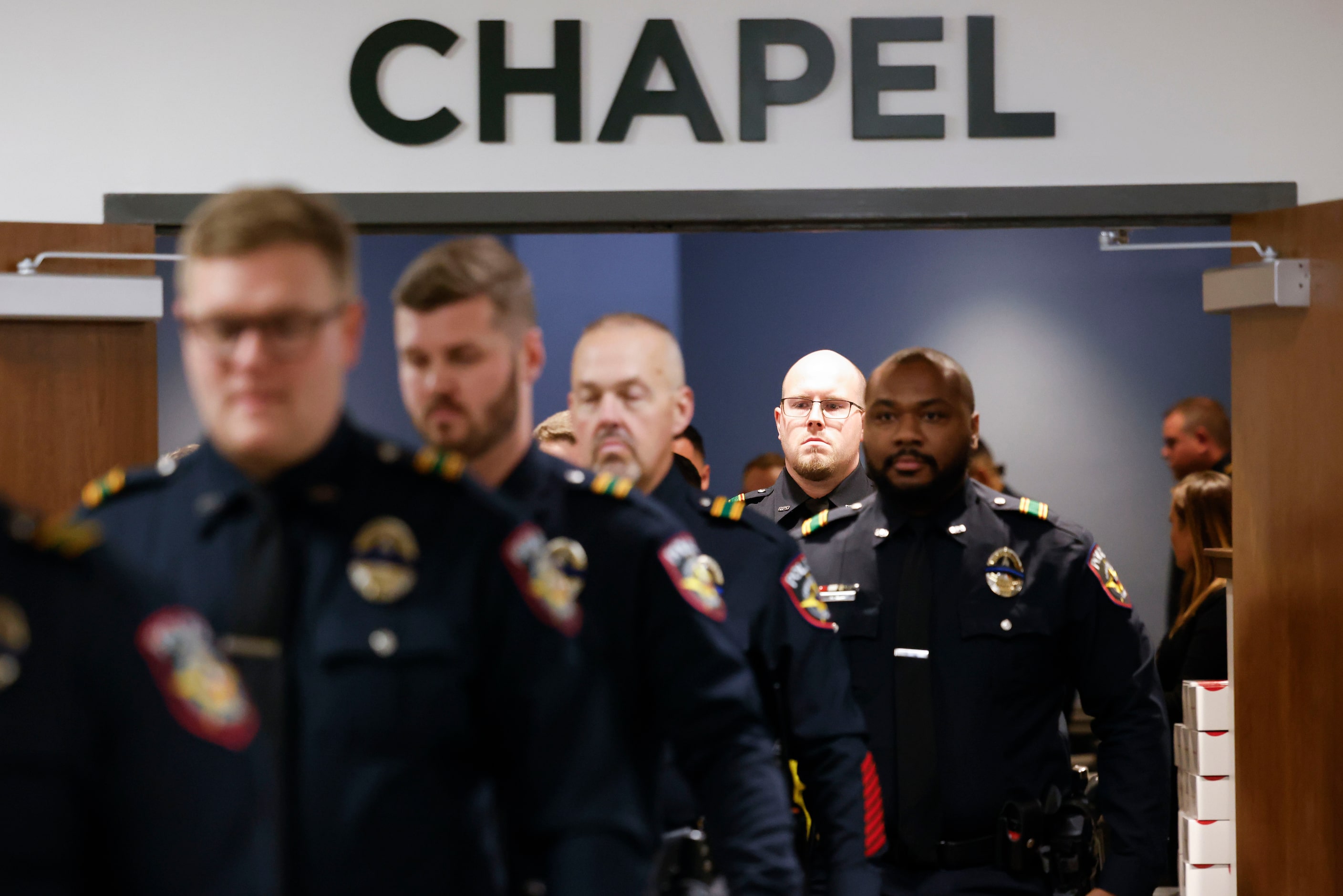 Greenville Police Department officers make their way into the funeral services for officer...