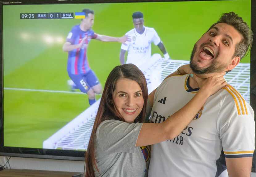 Futbol Club Barcelona fan Lesly Echeverry (cq), left, jokes with boyfriend Real Madrid fan...