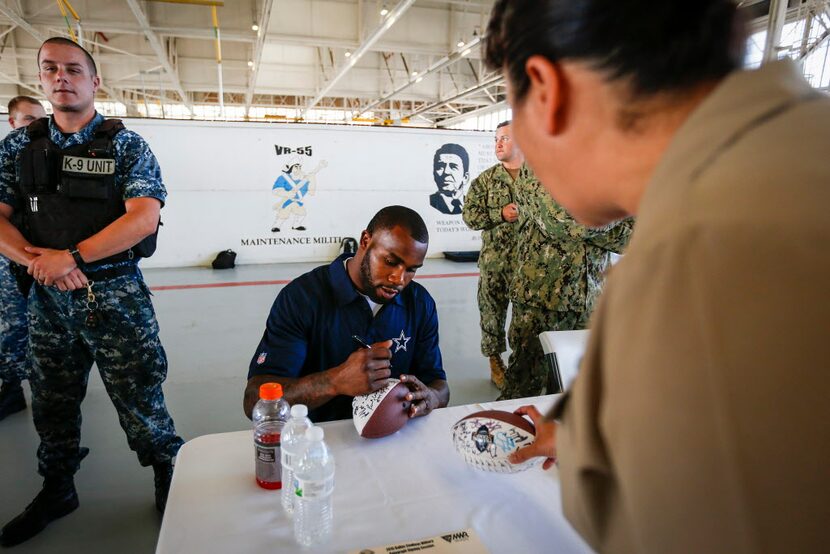 Dallas Cowboys running back Darren McFadden signs autographs for military personnel and...