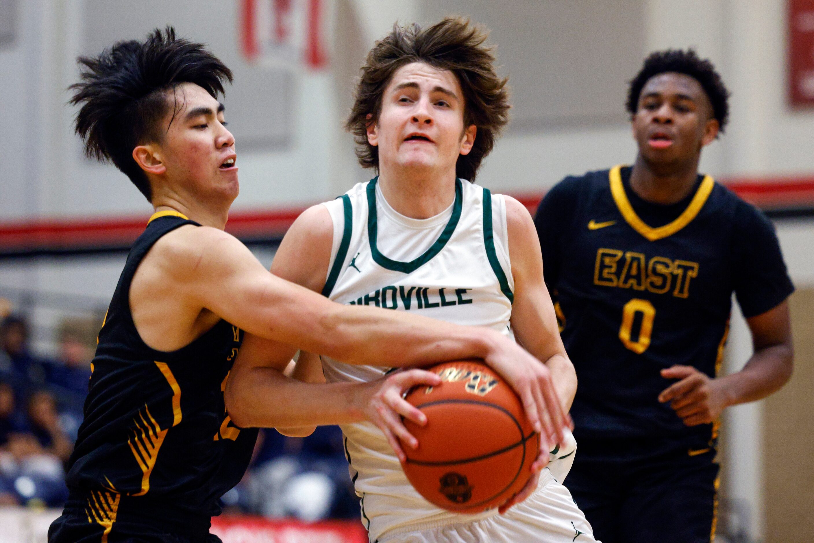 Plano East wing Jon Tran (12) steals the ball from Birdville guard Sawyer Dotson (21) during...