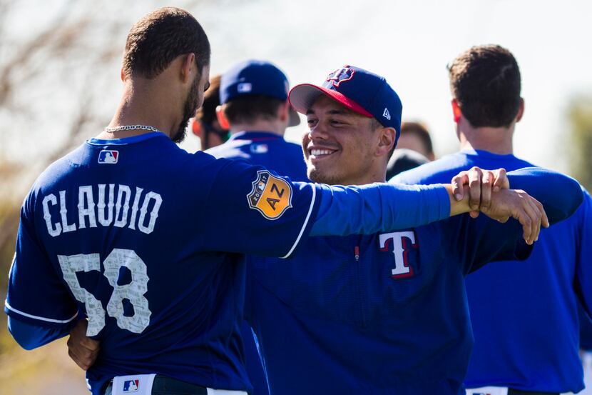 Texas Rangers relief pitcher Keone Kela (50) tries to dance with relief pitcher Alex Claudio...