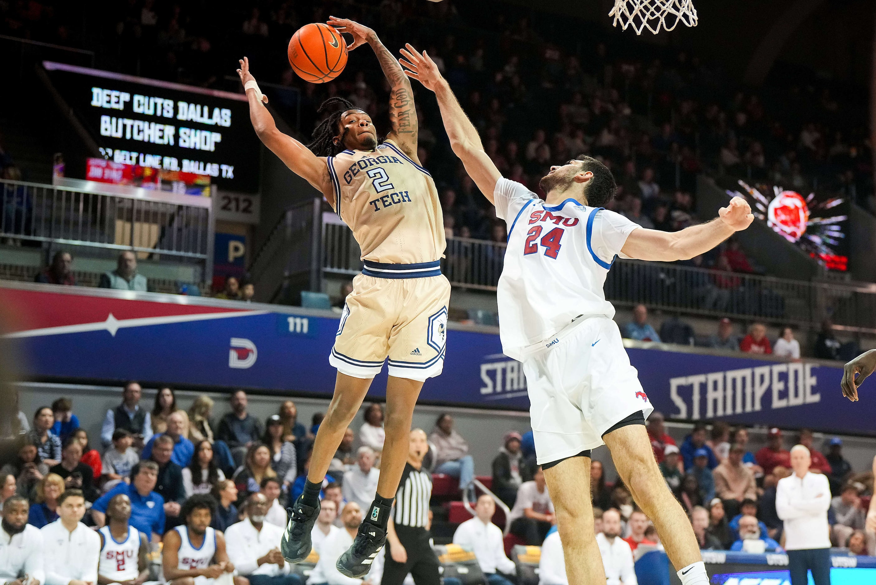 SMU center Samet Yigitoglu (24) fights for  a rebound against Georgia Tech guard Javian...