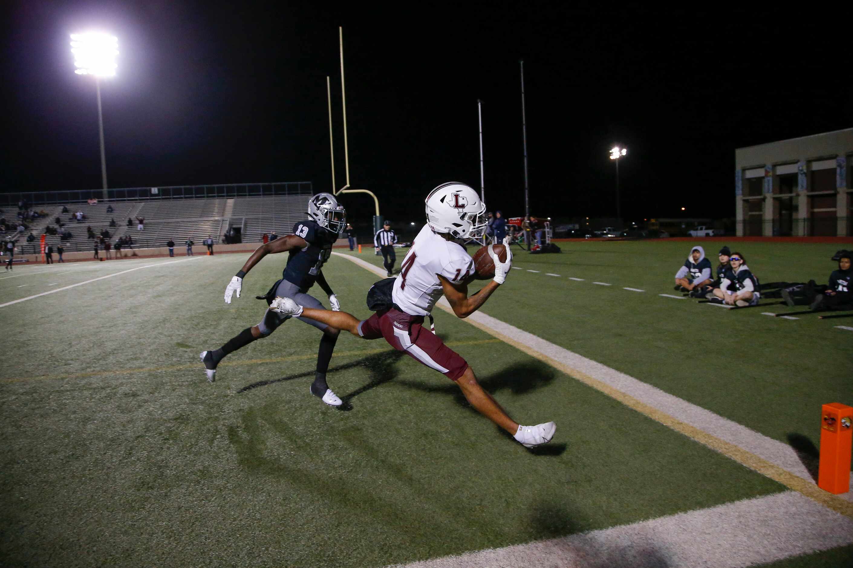 Lewisville senior wide receiver Kye Stone (14) catches a pass for a touchdown as Arlington...