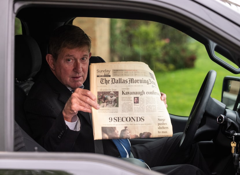 Michael Snipes holds a copy of The Dallas Morning News where an article was written about...