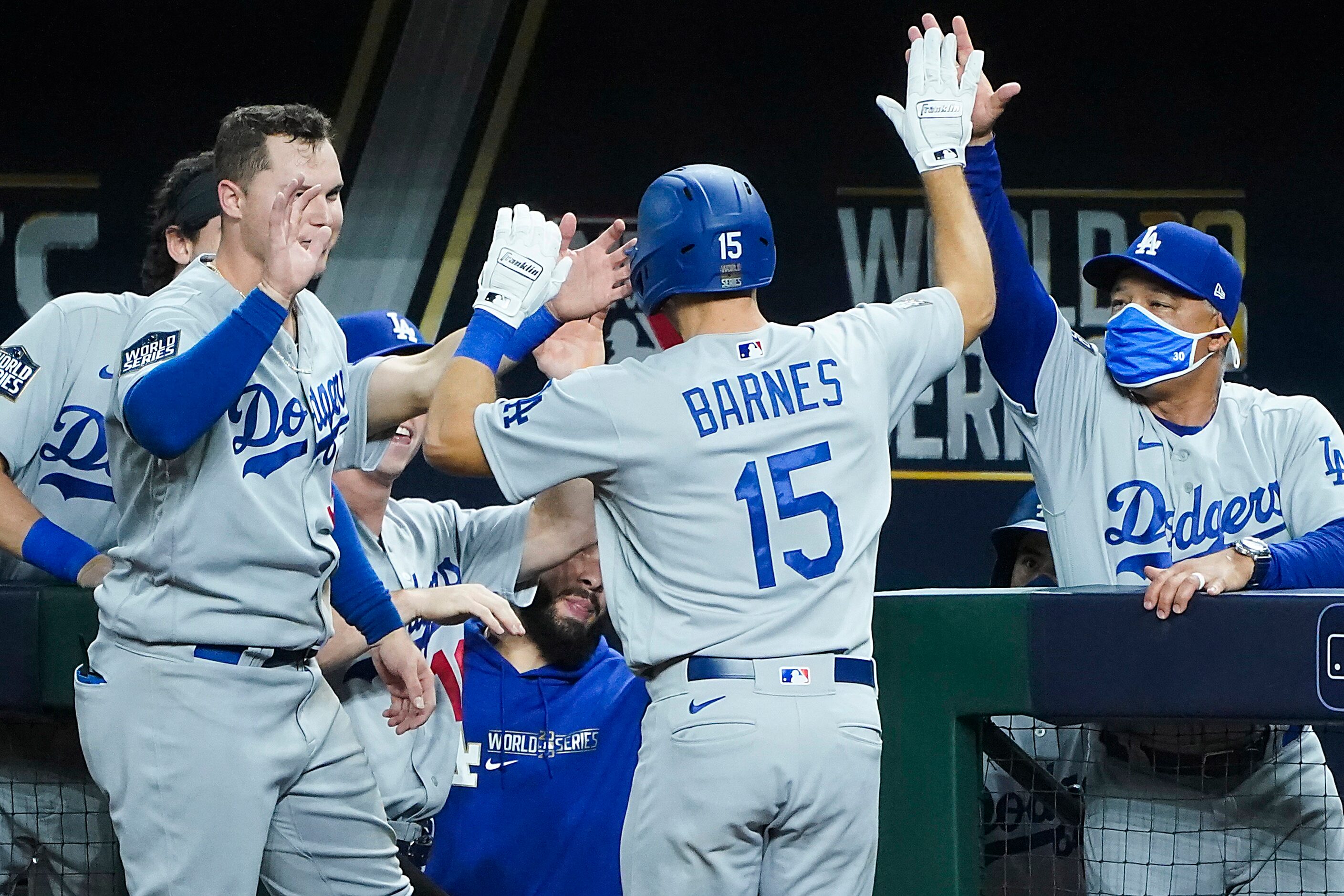 Los Angeles Dodgers catcher Austin Barnes (15) gets a hand from left fielder Joc Pederson...