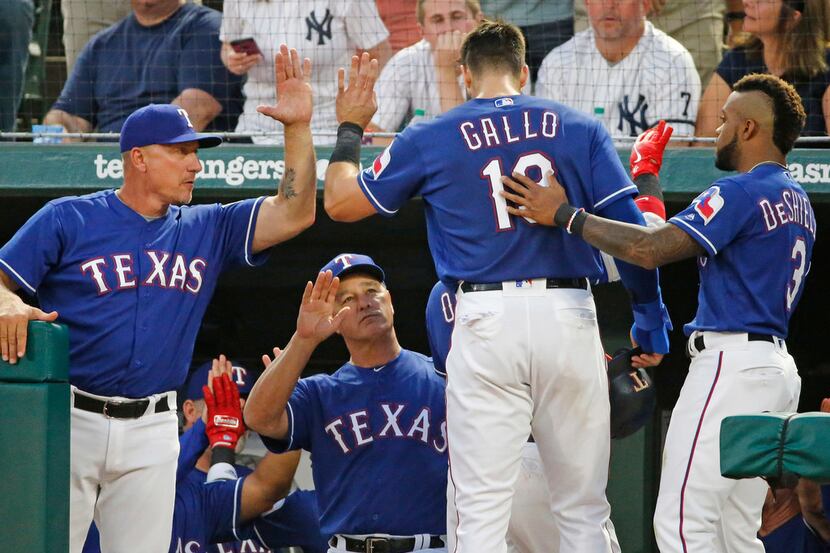 Texas Rangers manager Jeff Banister (28) congratulates Texas Rangers left fielder Joey Gallo...