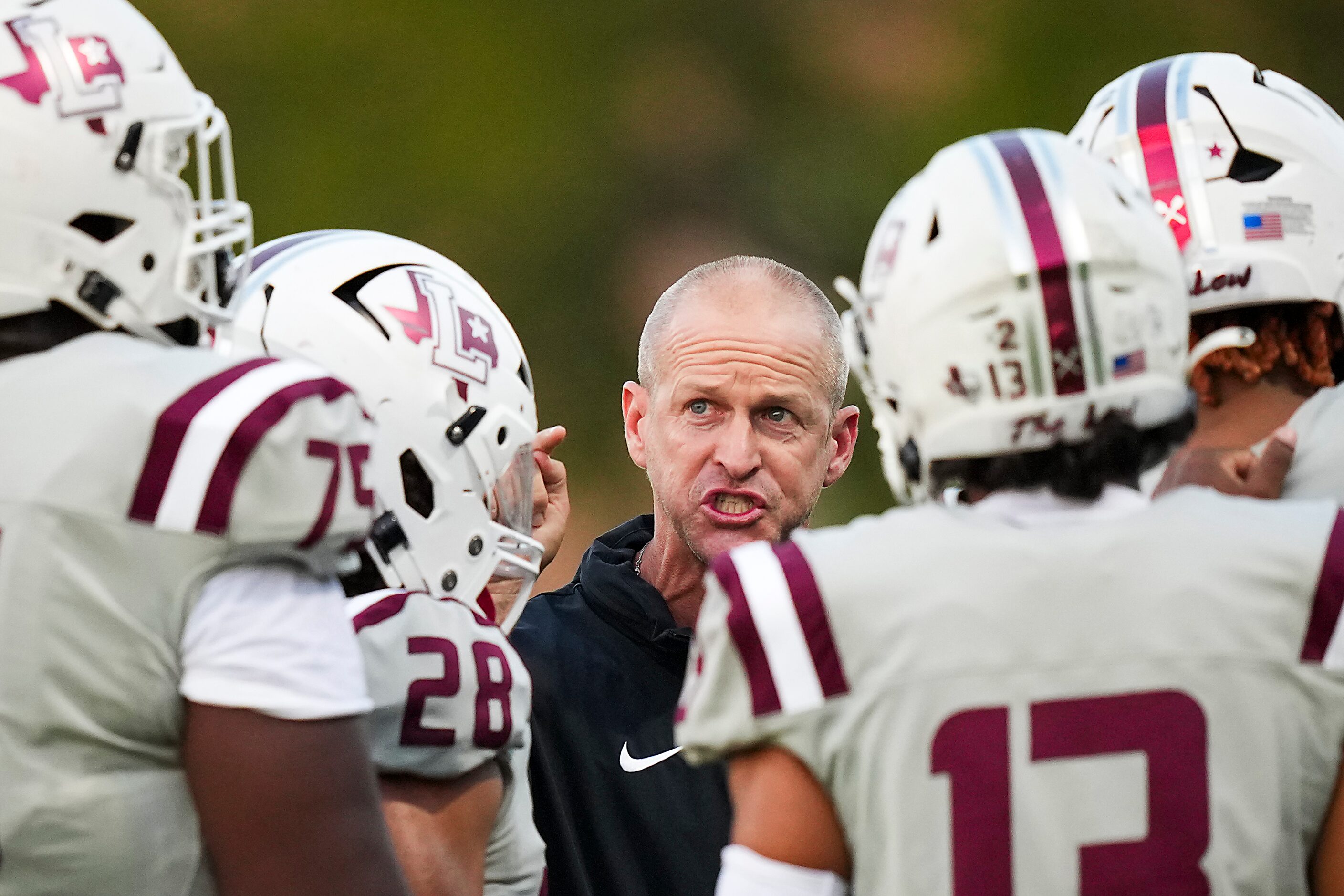 Lewisville head coach Michael Odle talks to players during a time out in the first half of a...