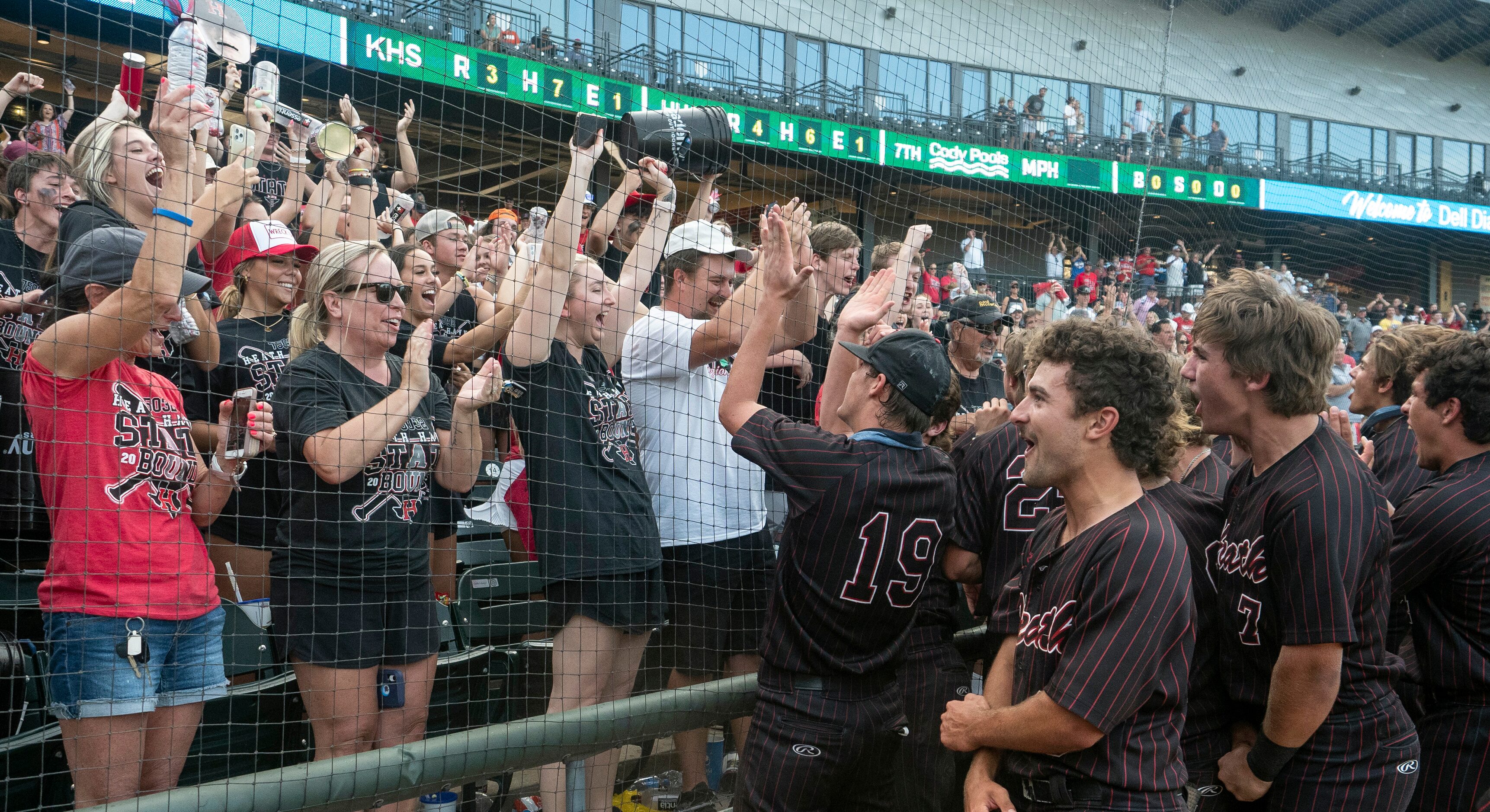 Members of the Rockwall-Heath Hawks team celebrate with fans after defeating Keller in the...