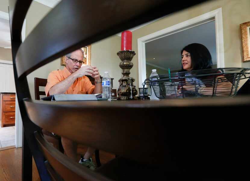 Lance Rogers, 61, is framed by a dining room chair as he has a private Spanish lesson in his...