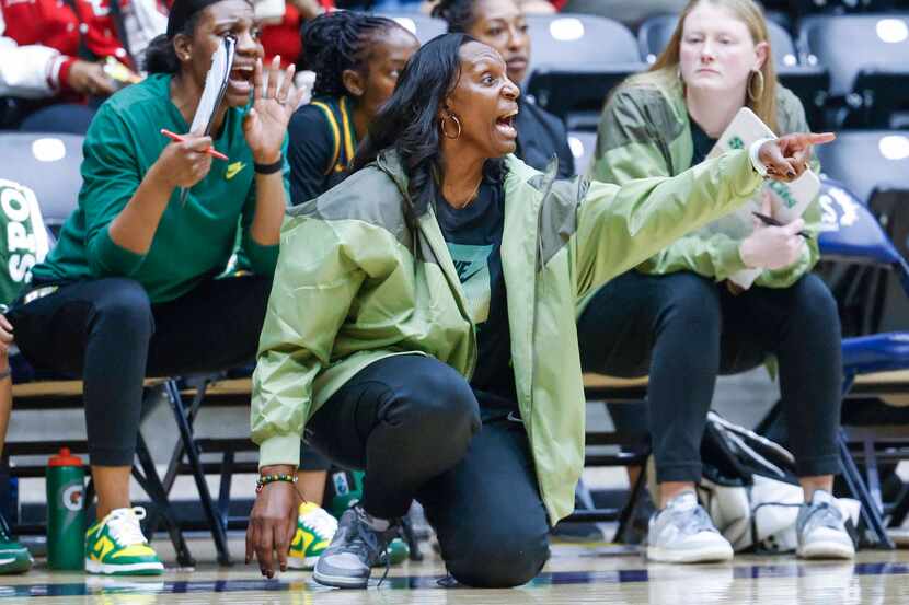 DeSoto coach Andrea Robinson instructs her team during the second half of a playoff...