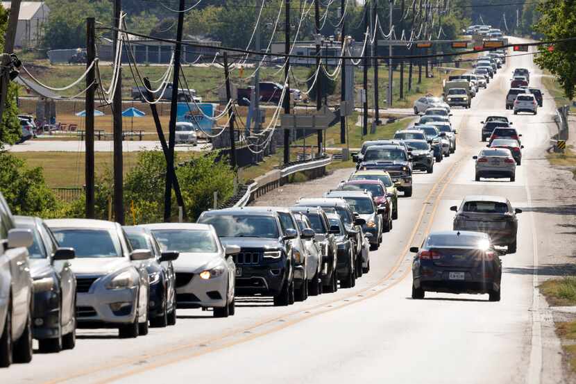 Traffic backs up along Main Street near downtown in Royse City, Texas, Thursday, Aug. 11, 2022.