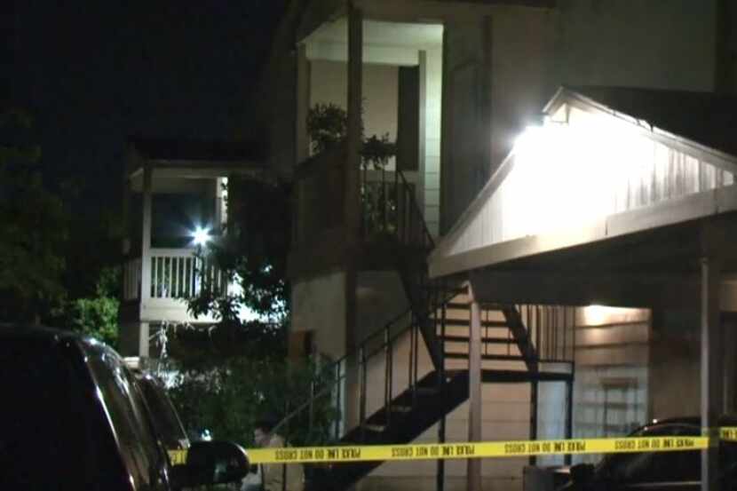 Crime scene tape blocks off an apartment where a body was discovered hidden in a bed...
