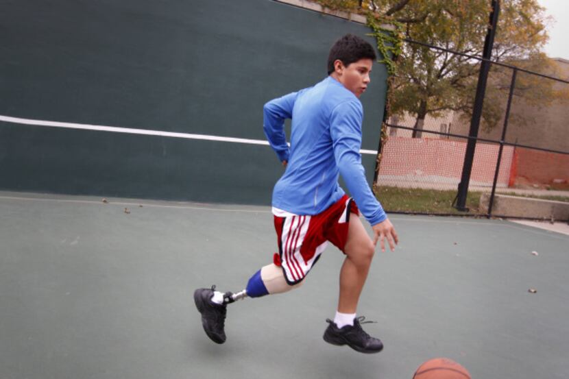 Mabeth Diaz, 13, plays basketball on at the Scottish Rite Hospital in Dallas while he tests...