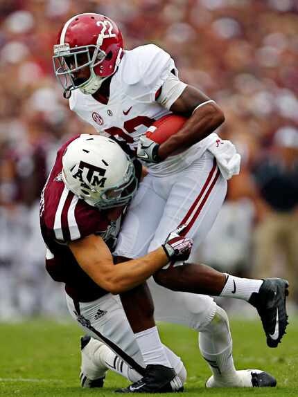 Clay Honeycutt (left) makes a hit on Alabama receiver Christion Jones during a 2013 game. 